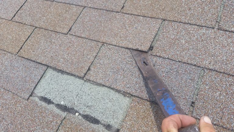 Loosen the shingles up by sliding the nail bar under the tab and breaking the bond between the two shingles