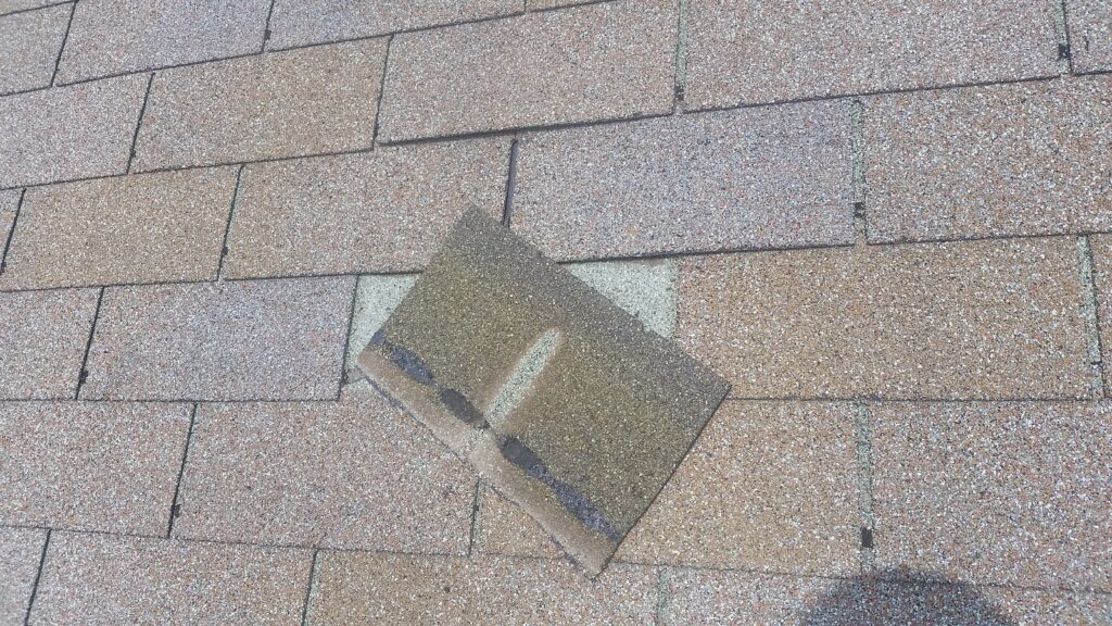 This is the remaining part of the shingle tab that did not blow off.