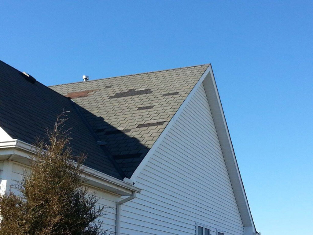 residential roof showing damaged shingles